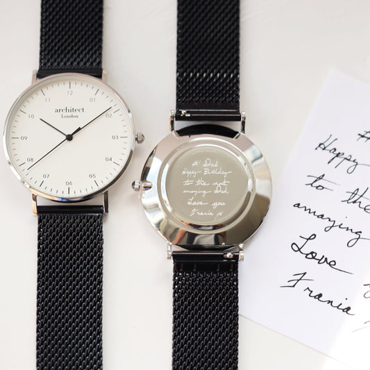 Two black mesh watches with engraved messages on a white background