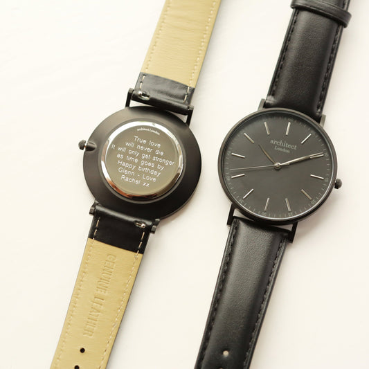 Two watches with leather straps on a white background