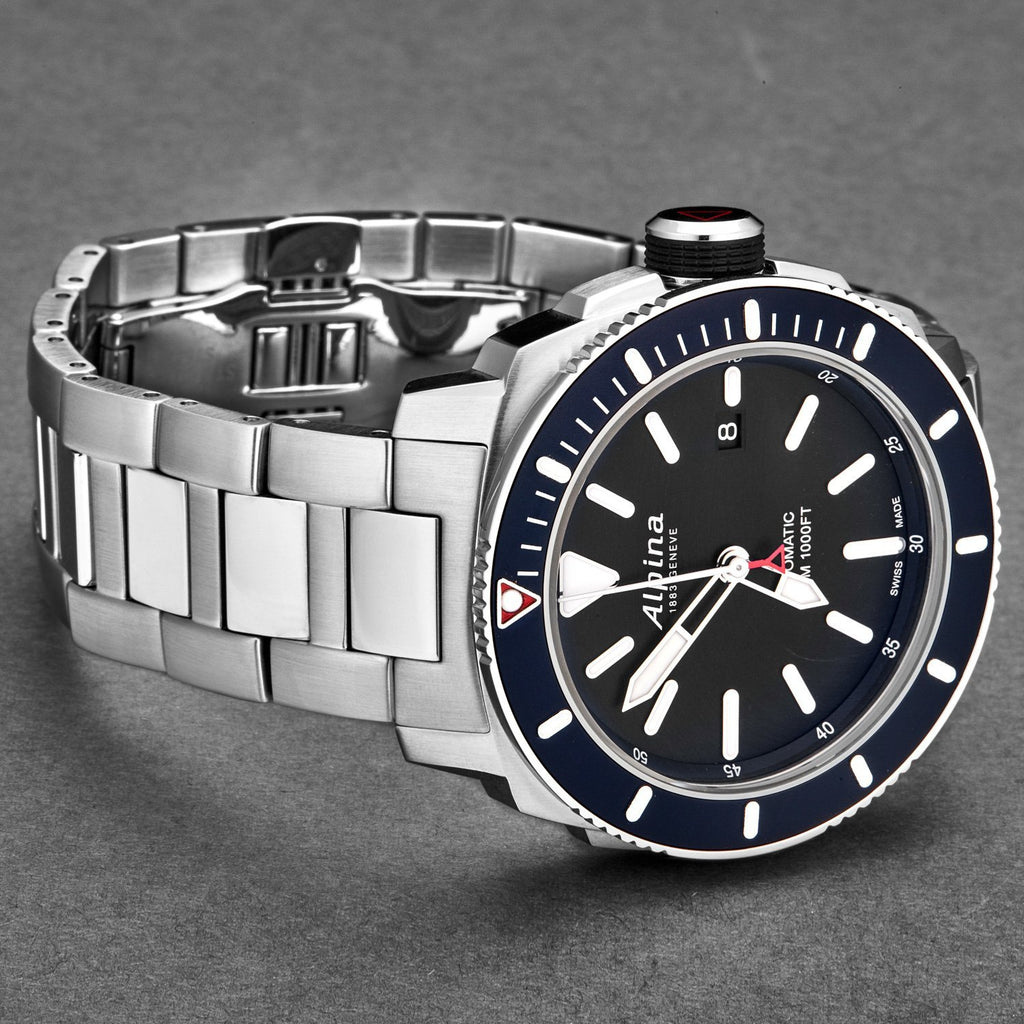 Silver watch with a black face and blue accents on a gray background
