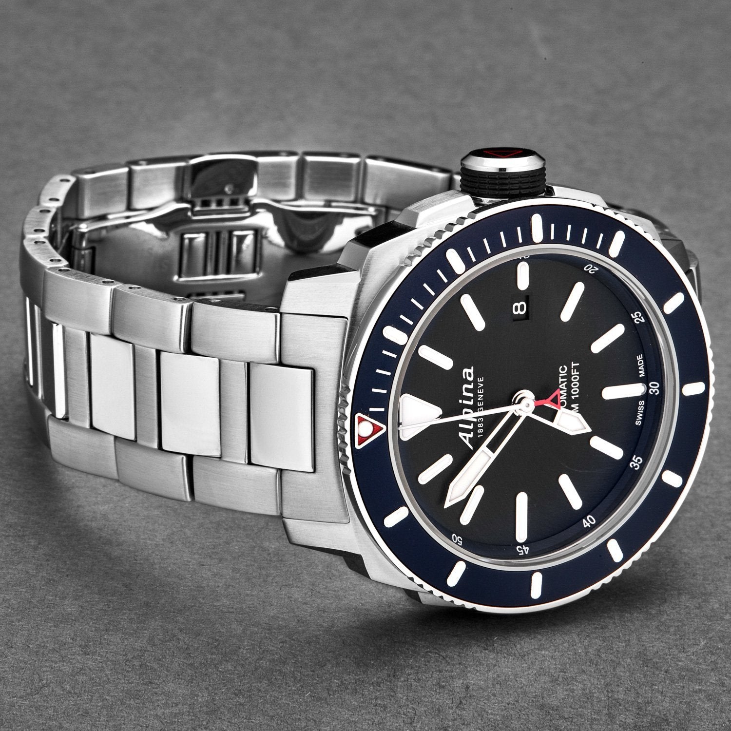 Silver watch with a black face and blue accents on a gray background