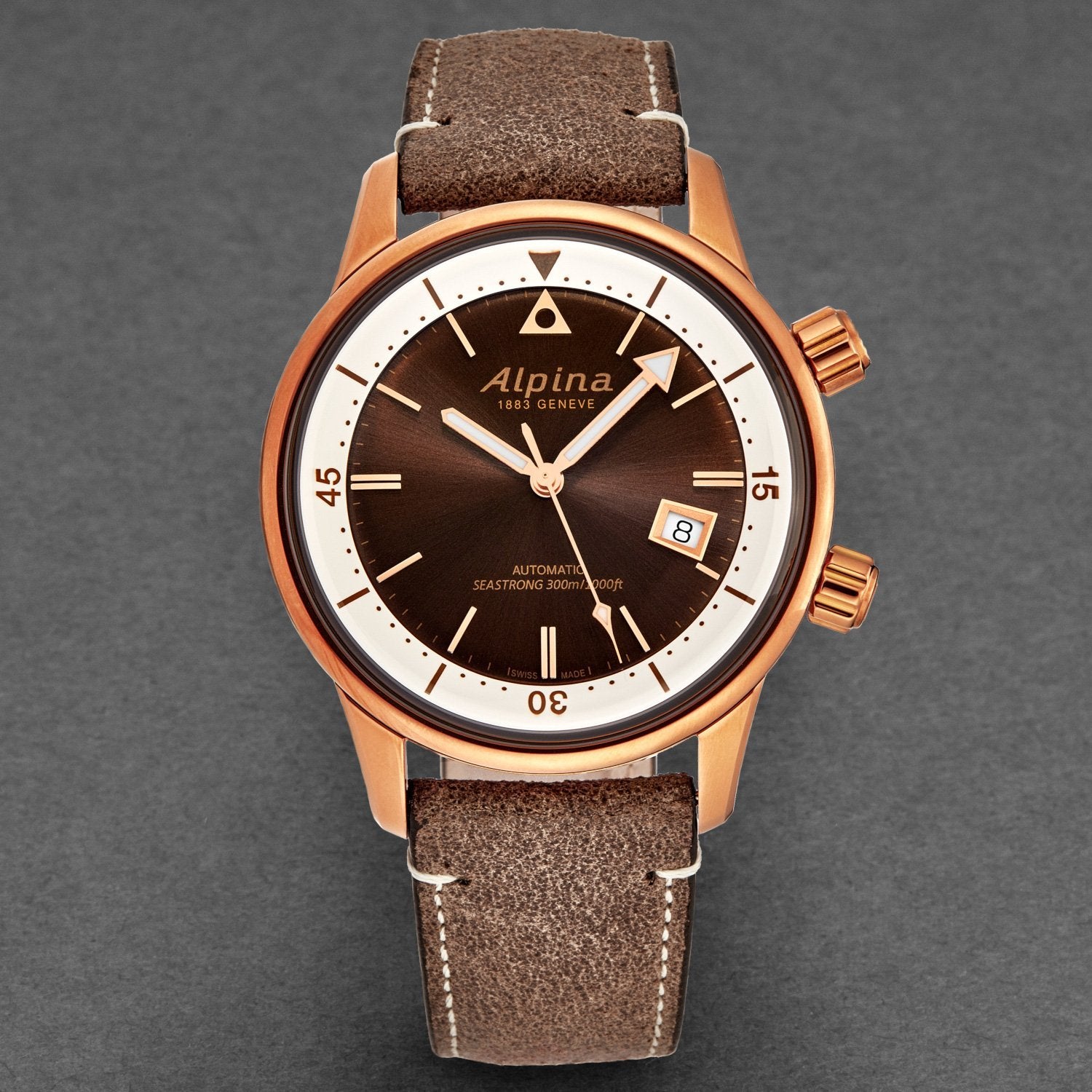 Brown wristwatch with Alpina brand on a gray background
