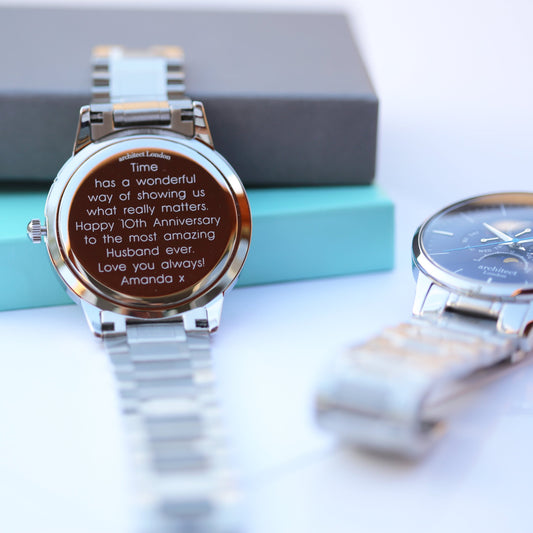 Silver watch with a engraved message on a light background