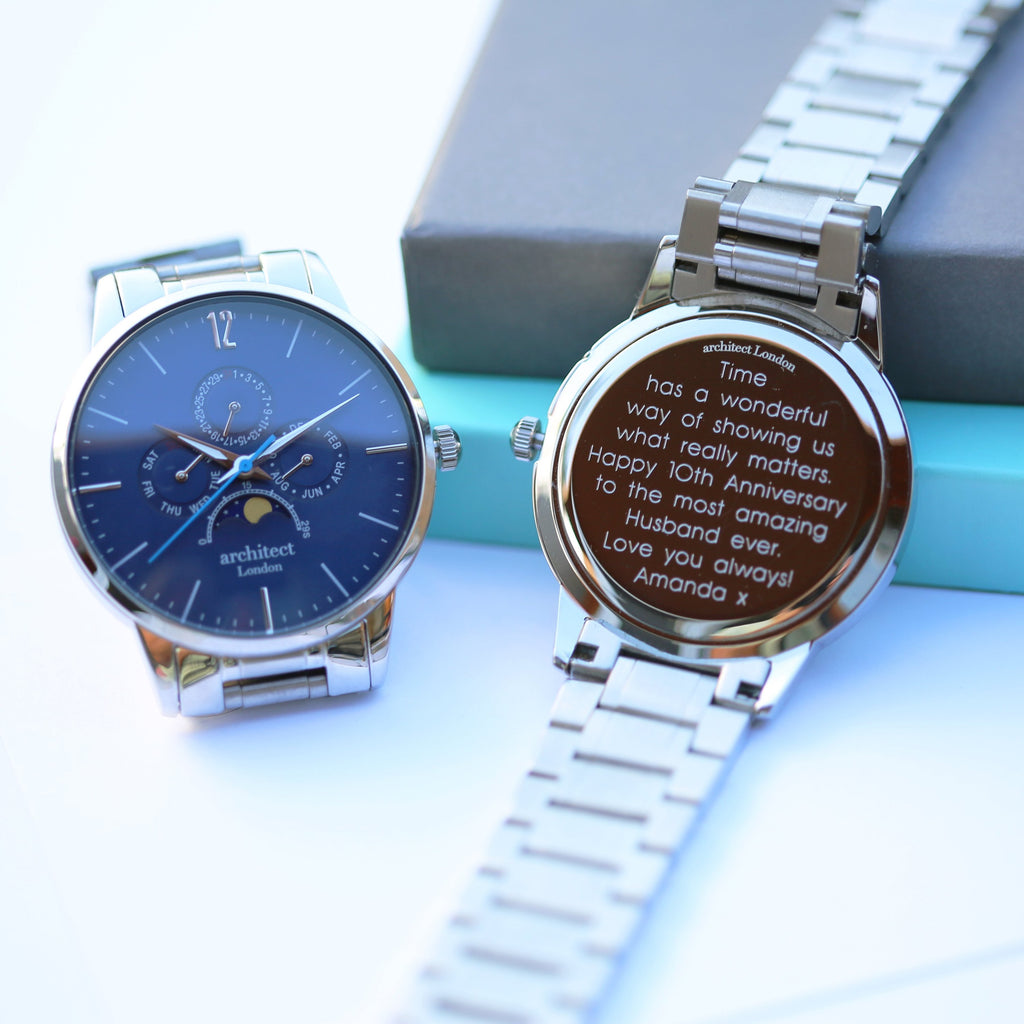 Two silver watches with one displaying a personalized message on a light blue background