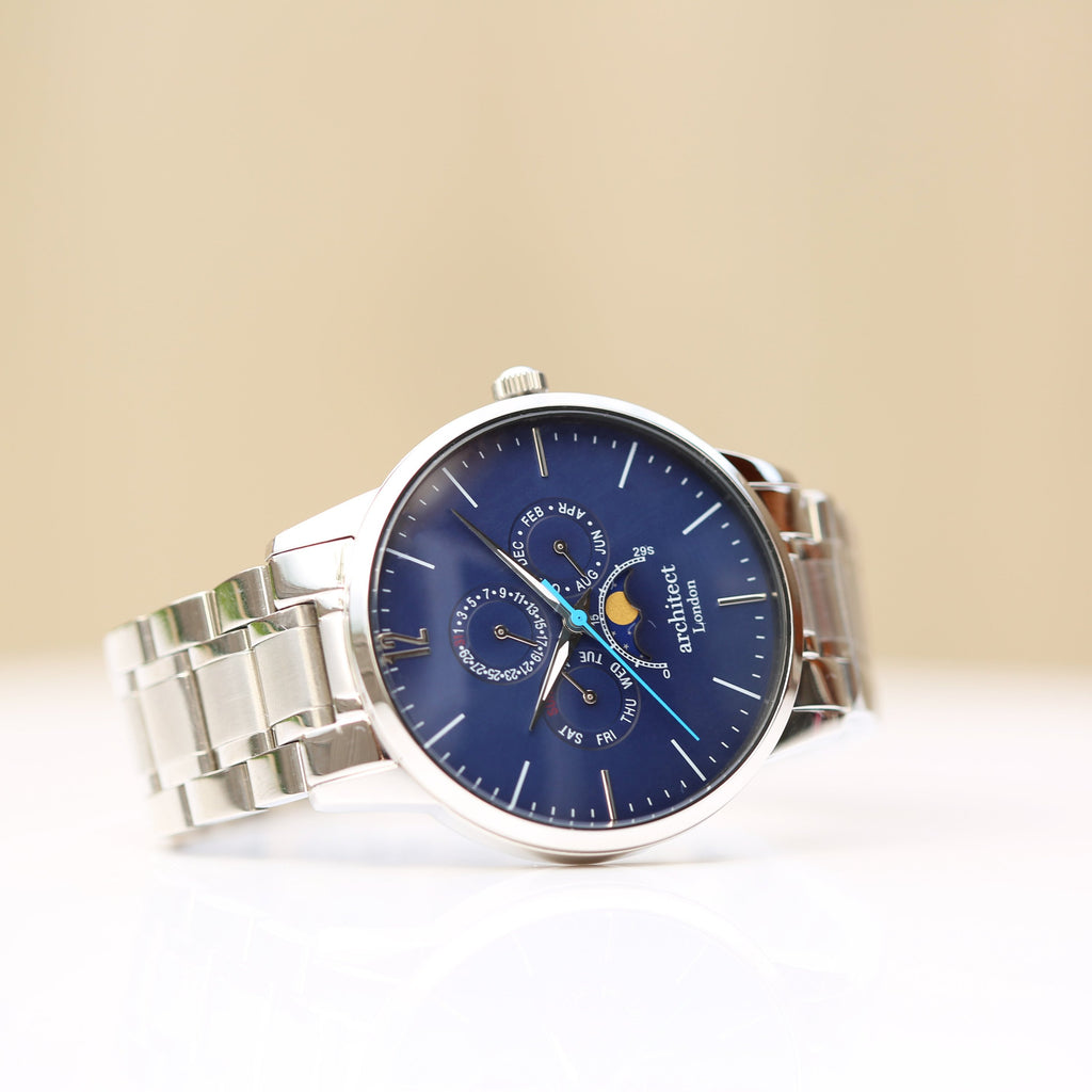 Silver wristwatch with a blue face on a beige background