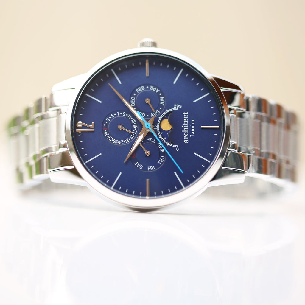 Silver watch with a blue face on a white background