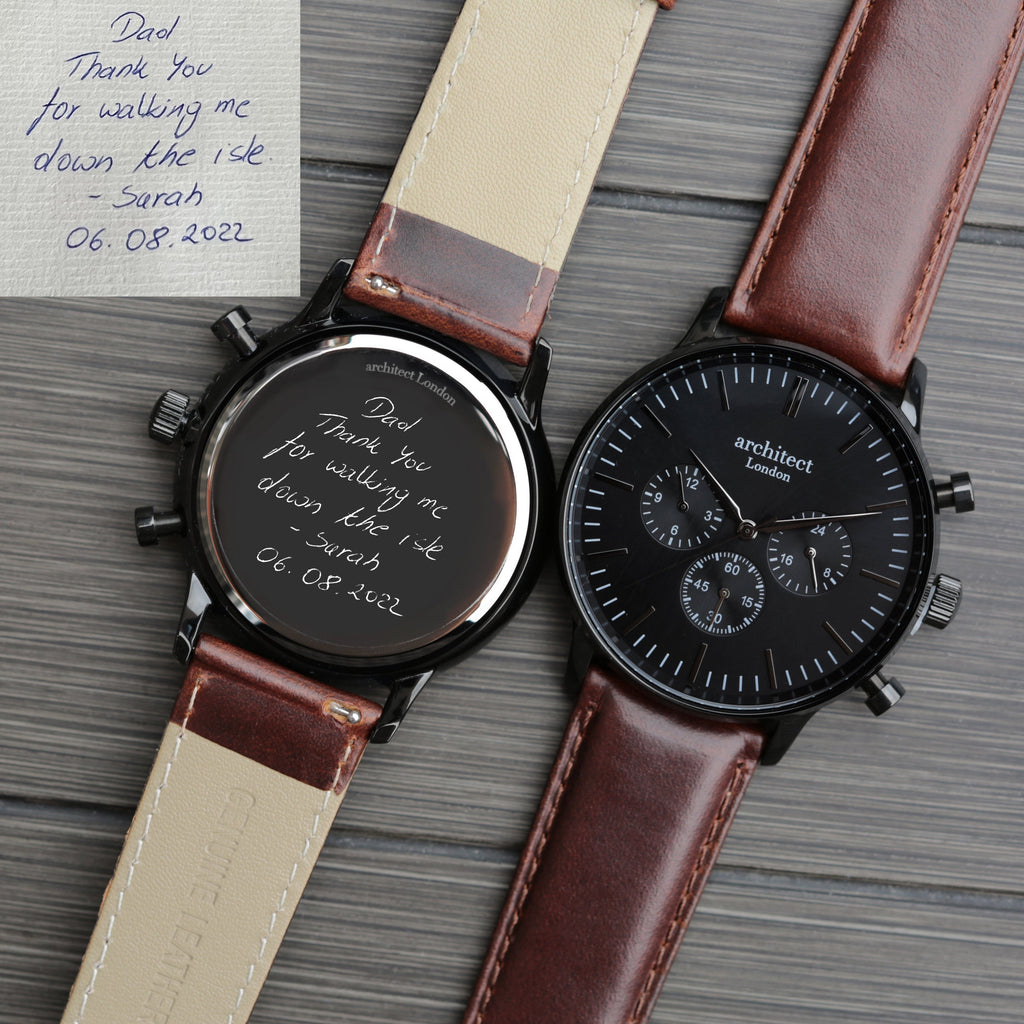 Two watches with brown straps on a textured surface, one with a handwritten note.