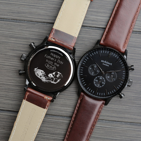 Two watches with brown leather straps on a wooden surface