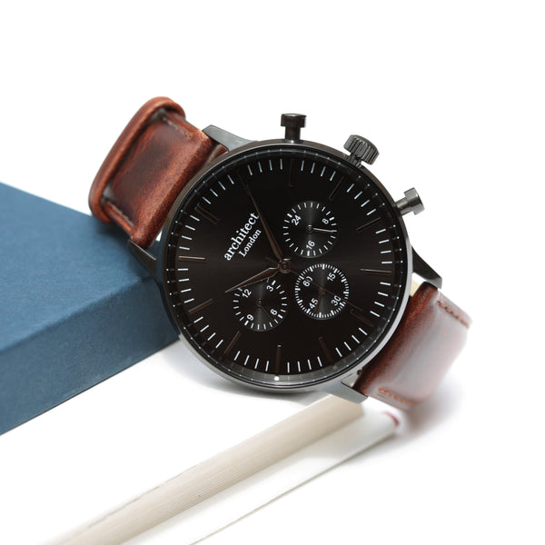 Wristwatch with brown leather strap on a white background