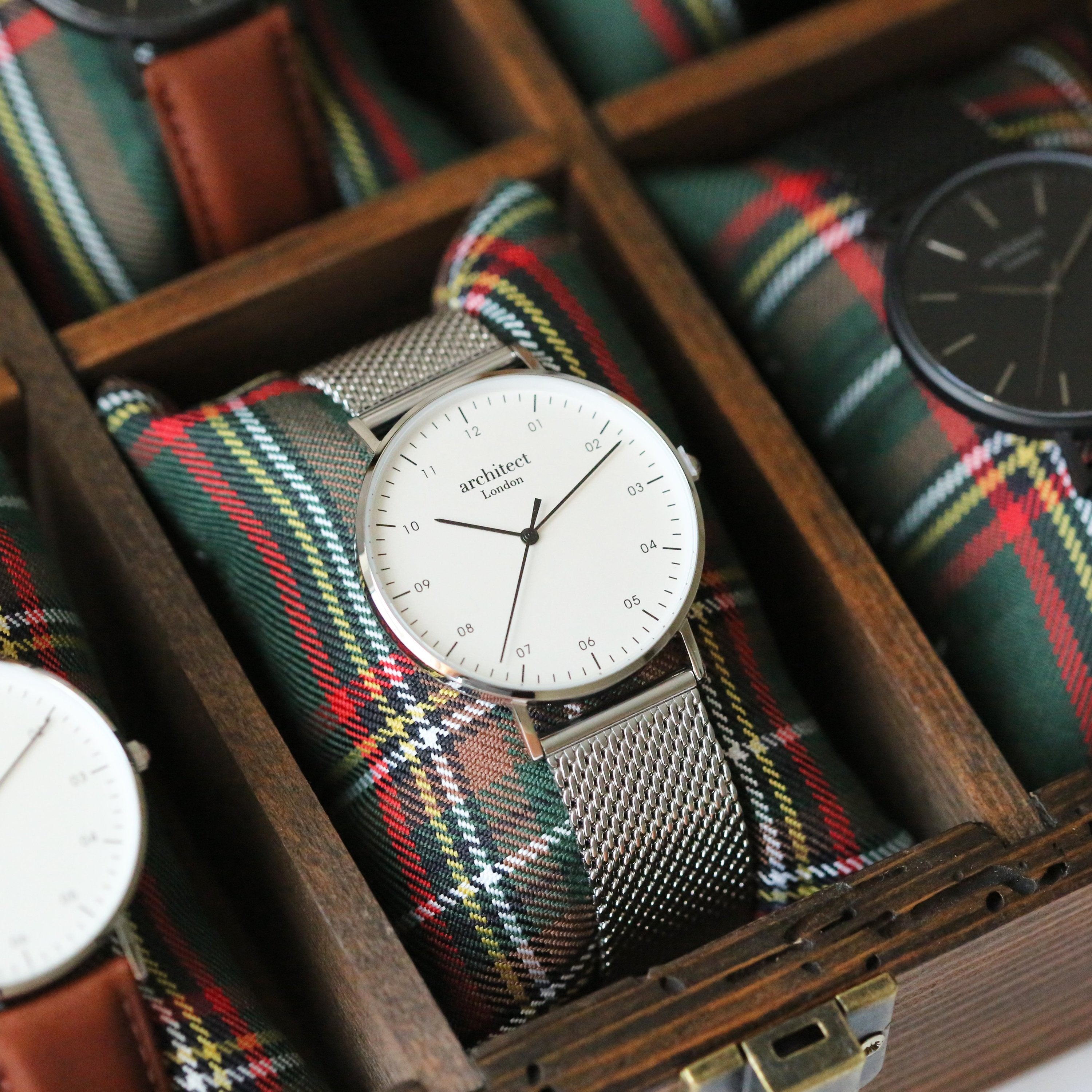 Watch with a plaid strap in a wooden box