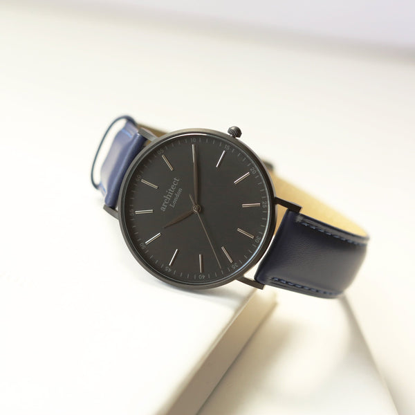 Black watch with blue strap on a white background