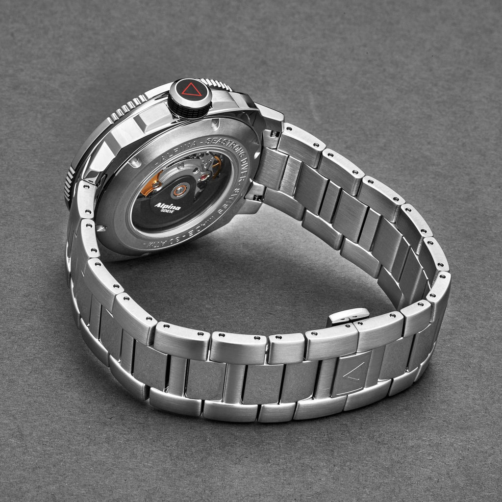 Silver watch with a detailed face on a gray background
