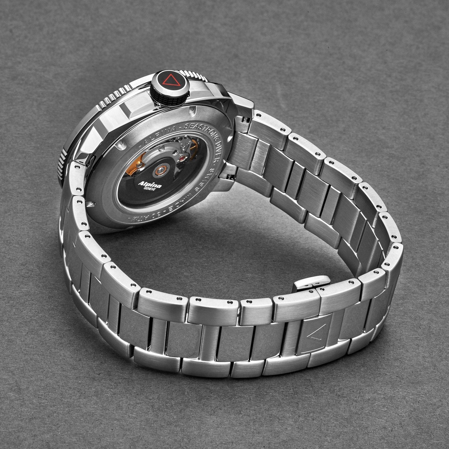Silver watch with a detailed face on a gray background