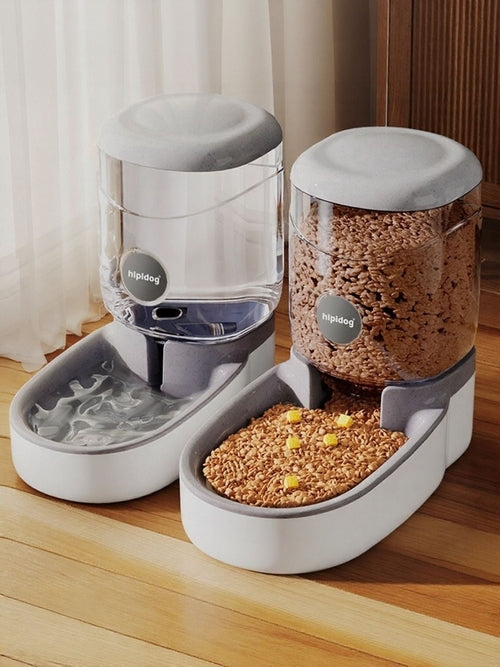 Pet feeding station with water and food containers on a wooden floor.