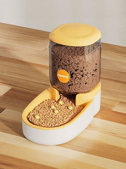 Pet food dispenser with brown pet food on a wooden surface