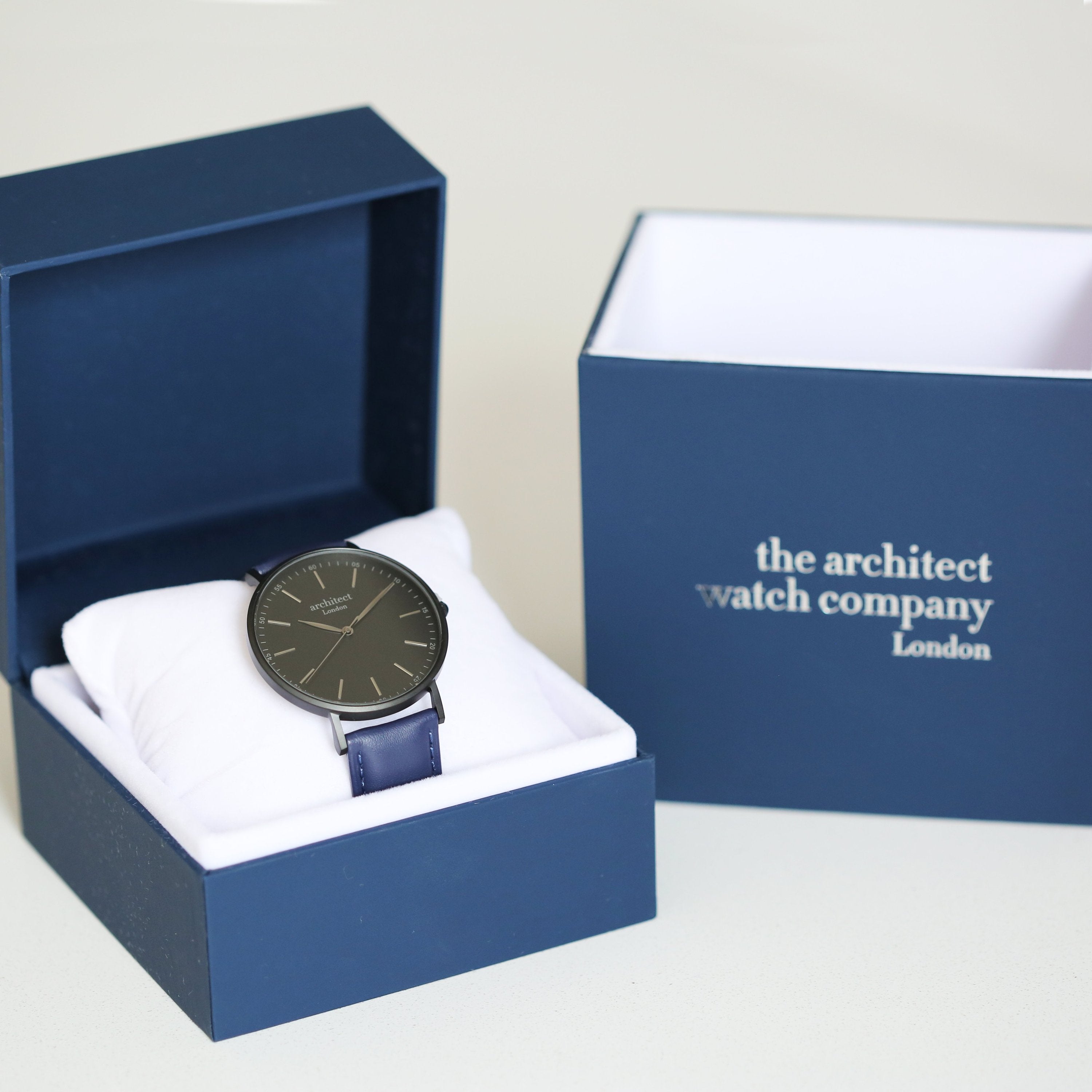 Watch in a blue box with 'the architect watch company London' branding.