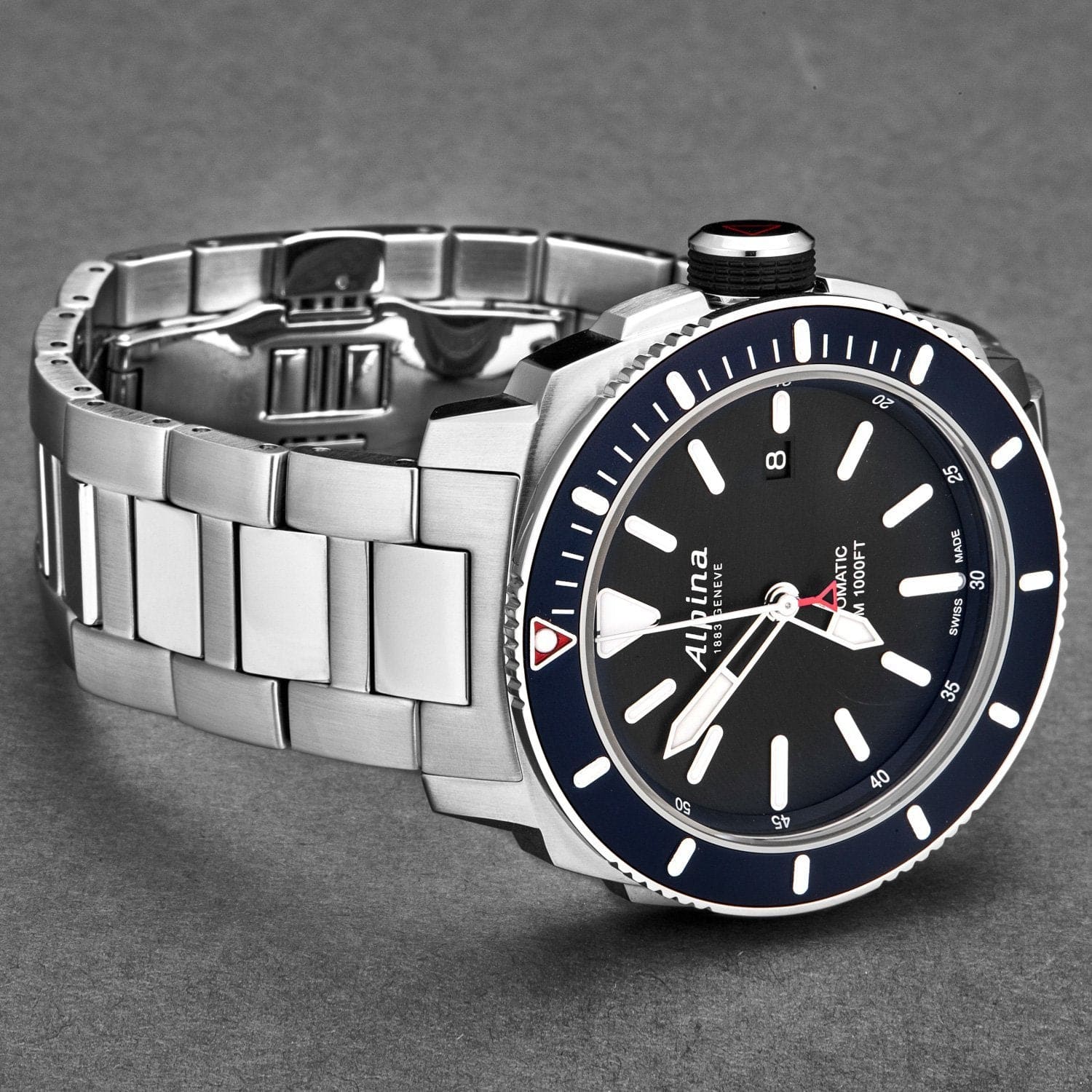 Silver watch with a black face and blue accents on a gray background