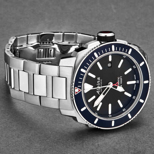 Silver watch with a black face and blue accents on a gray background