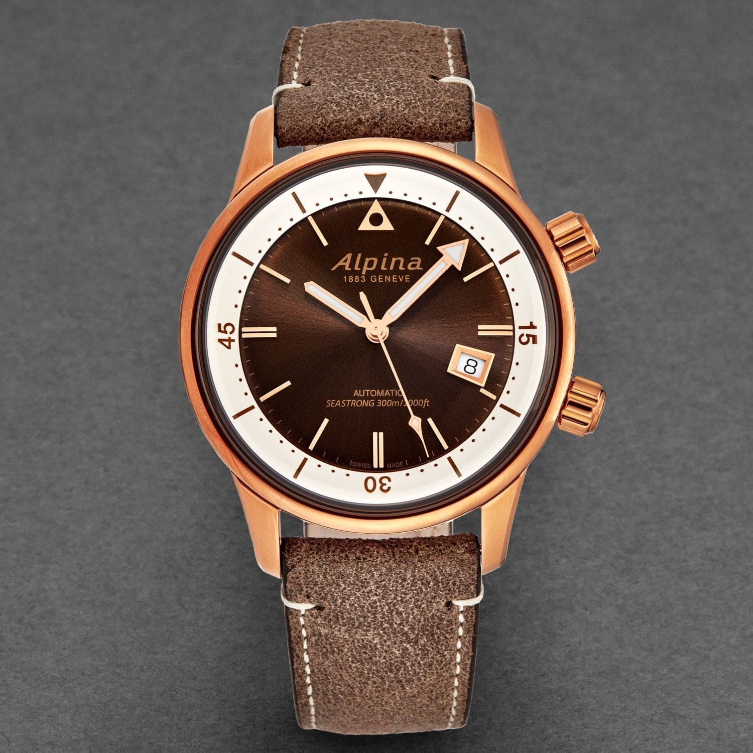 Alpina watch with brown leather strap on a gray background