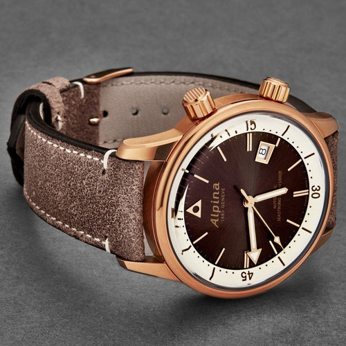 Watch with brown leather strap and rose gold case on a gray background