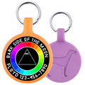 Two dog tags, one orange with a rainbow-colored circle and text, the other purple with a dog silhouette.
