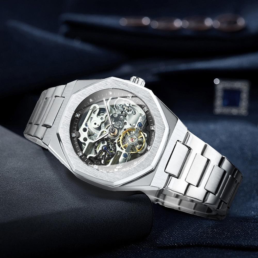 Silver wristwatch with intricate mechanical details on a dark background